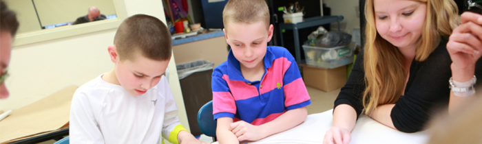 students drawing with teacher