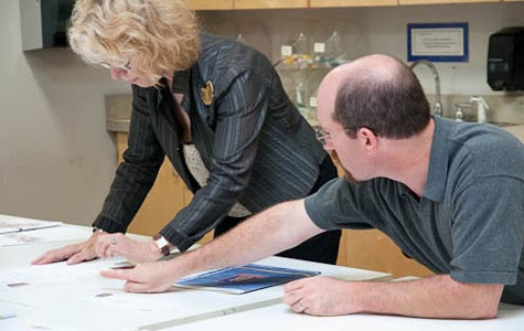 photo of teacher and student examining artwork